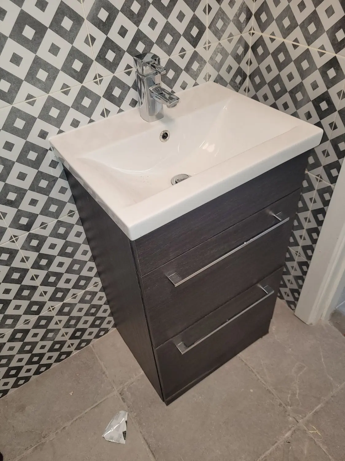 Modern bathroom vanity and patterned tile detail